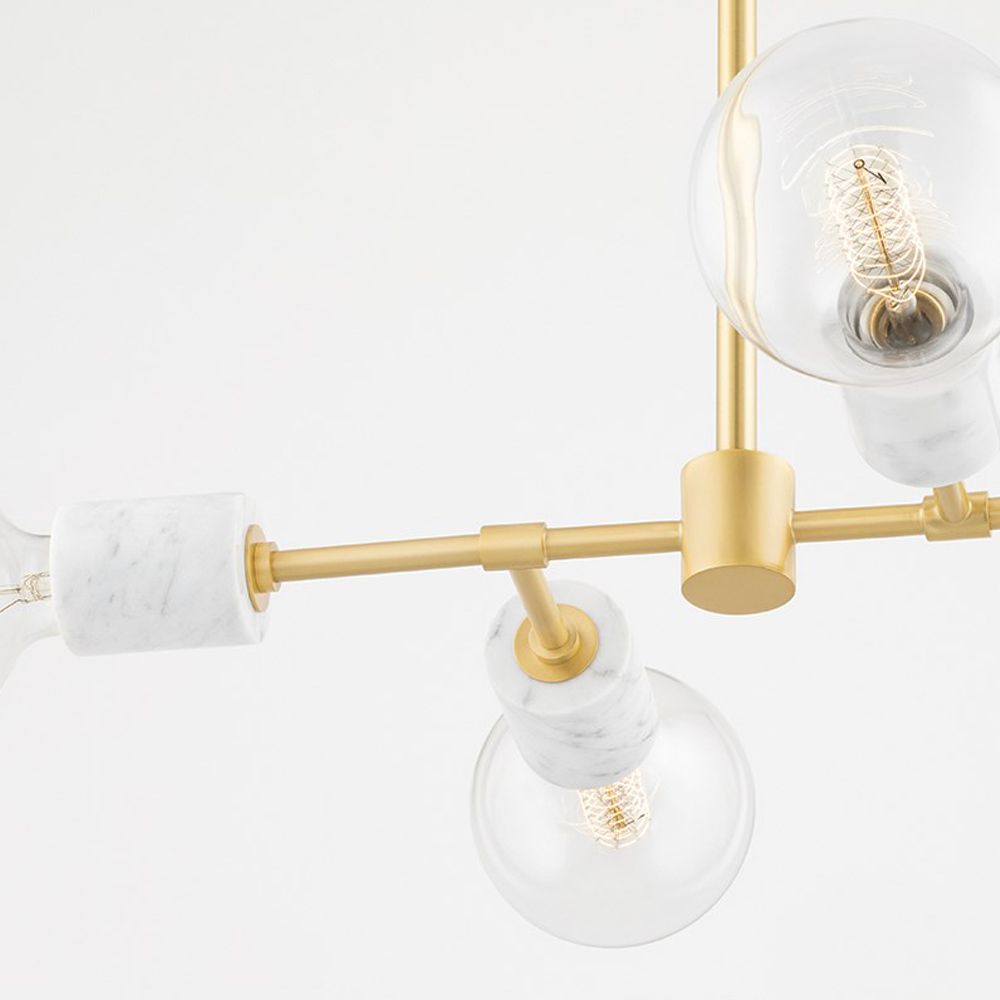 A glamorous aged brass ceiling lamp with glass lampshades and marble accents
