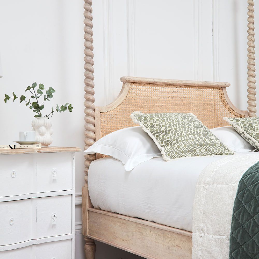 A luxurious acacia and cane 4 poster bed with a rattan headboard