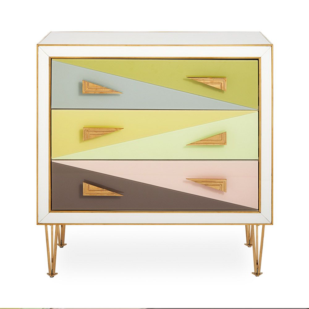 A modern Italian-inspired chest of drawers with angular hardware and brass accents