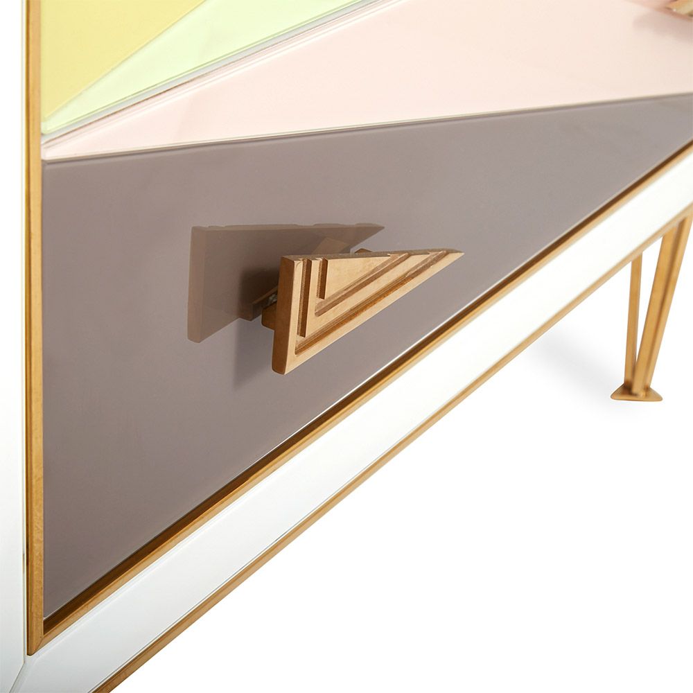 A modern Italian-inspired chest of drawers with angular hardware and brass accents