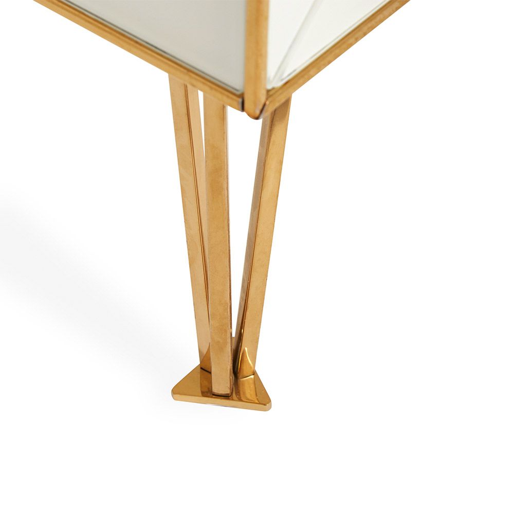 A modern Italian-inspired chest of drawers with angular hardware and brass accents