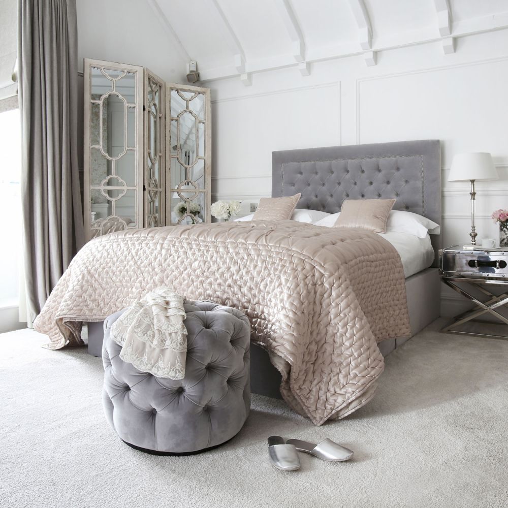 Luxury, deep buttoned pouffe upholstered in luxury grey velvet