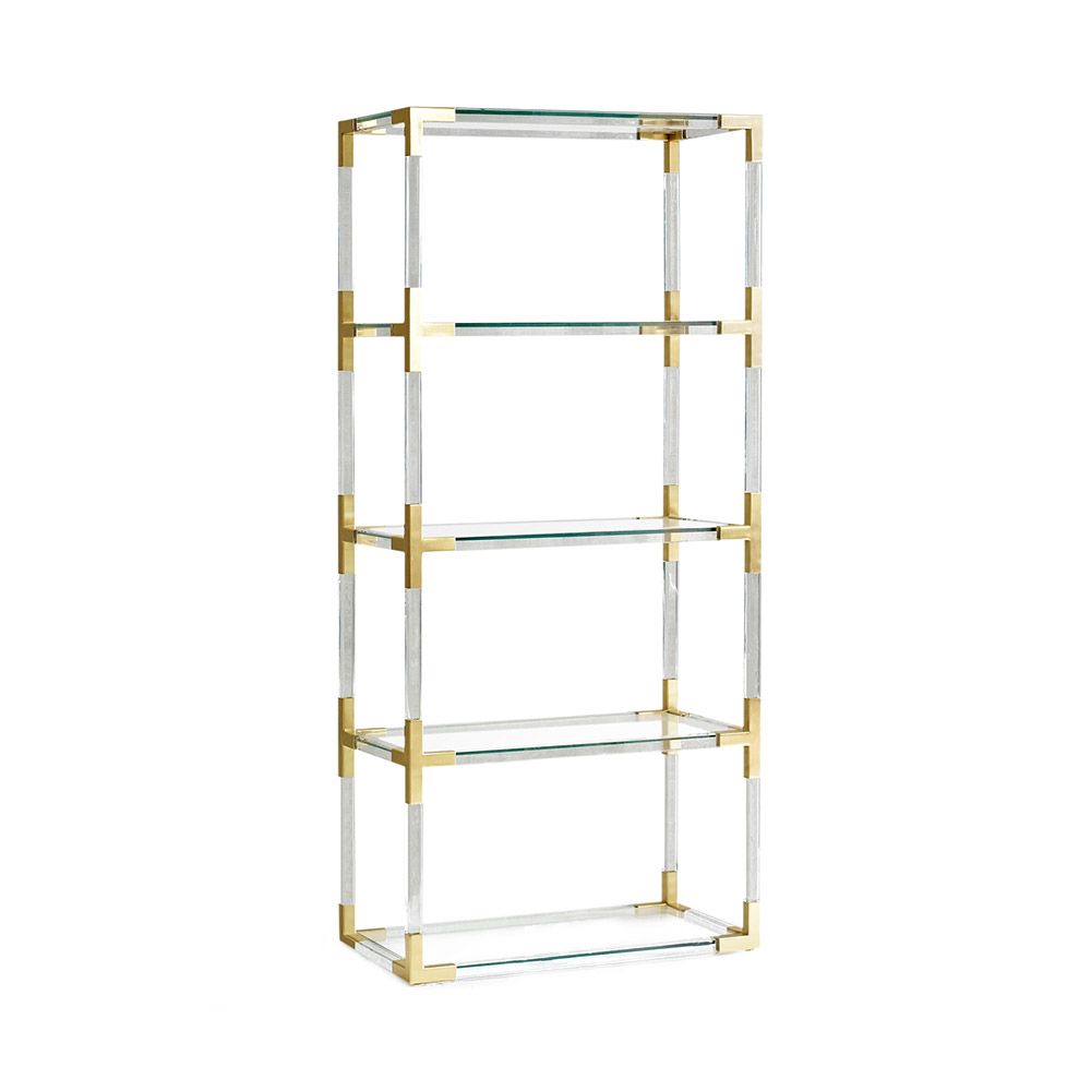 A brushed brass and acrylic shelving unit