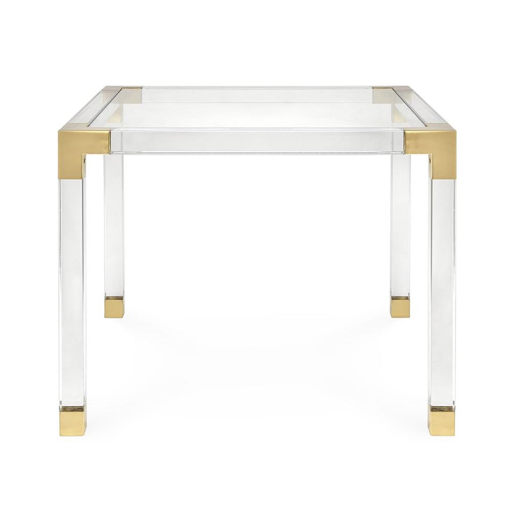A contemporary brass and acrylic games tale with a glass surface