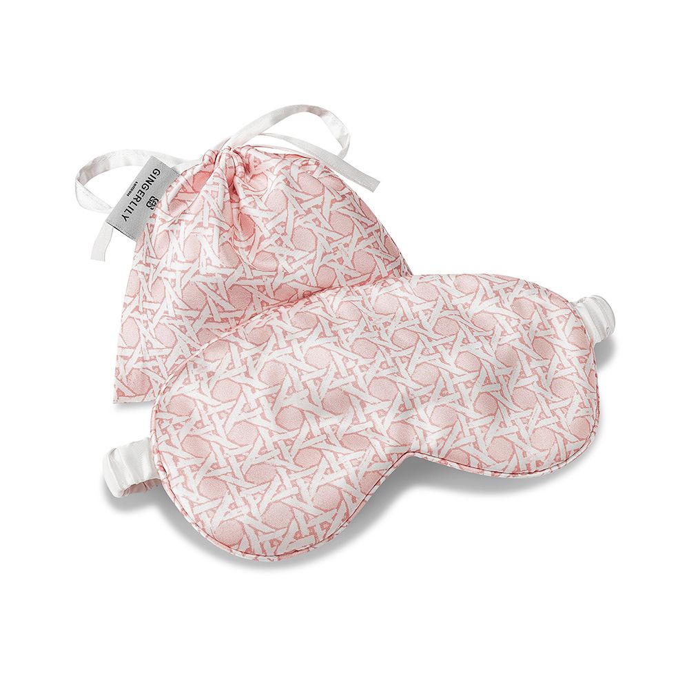 A glamorous silk eye mask with a rattan pink design on a gorgeous ivory background and complete with a drawstring pouch