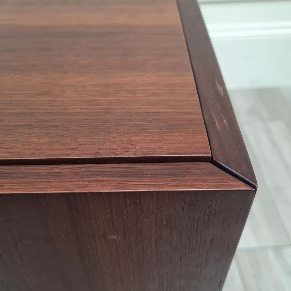 An eight drawer chest with gold painted steel handles and base