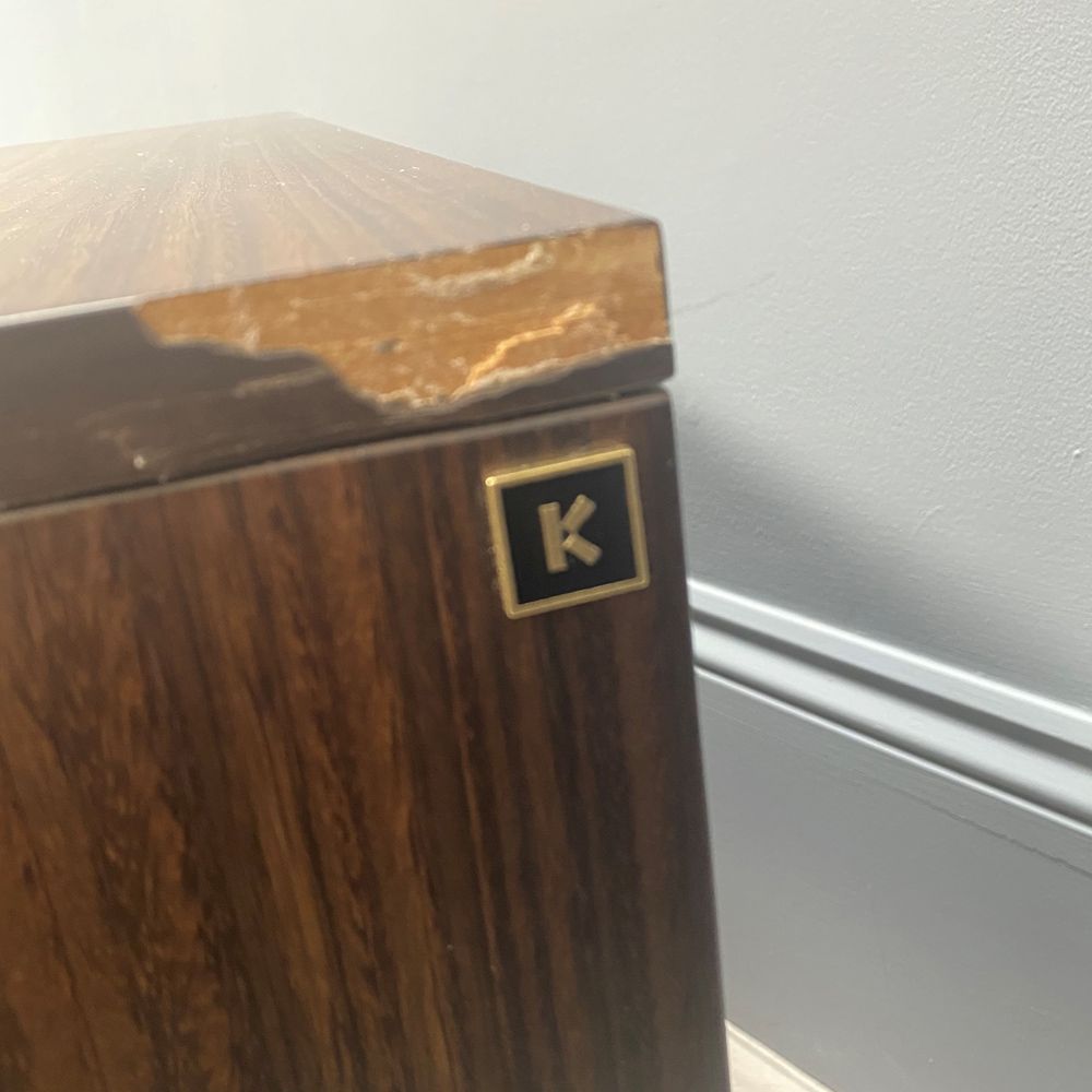 A luxurious smoked oak and gold metal bedside table