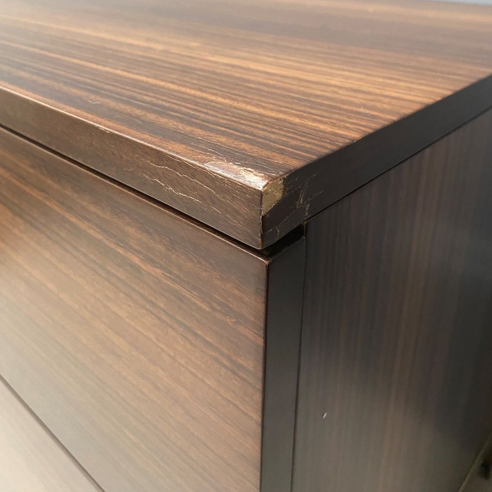 A luxurious smoked oak and gold metal bedside table