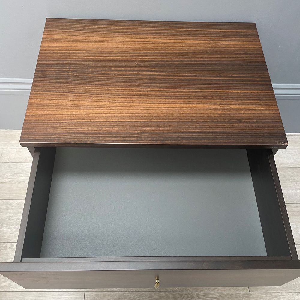 A luxurious smoked oak and gold metal bedside table
