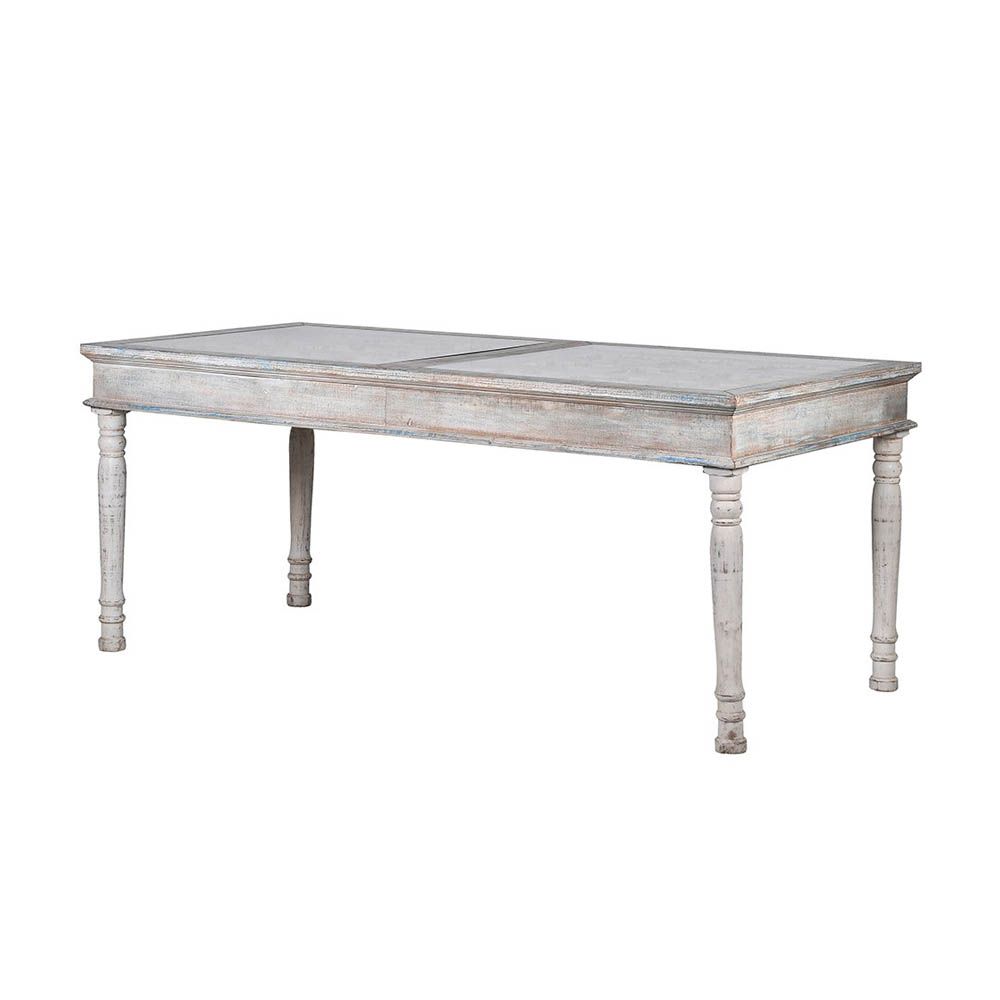 Intricately carved dining table in a light washed-wood