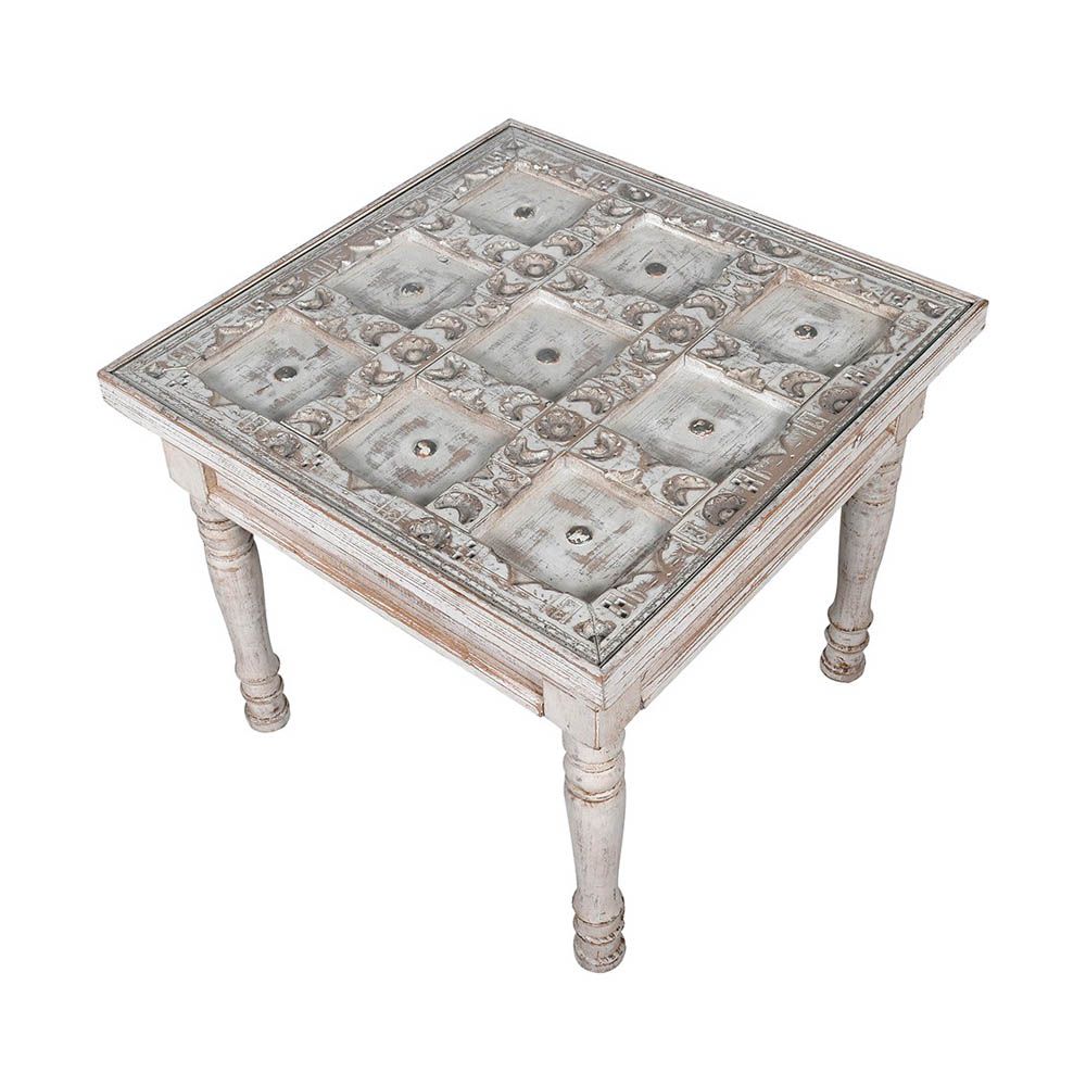 washed wood side table with intricate carved detailing