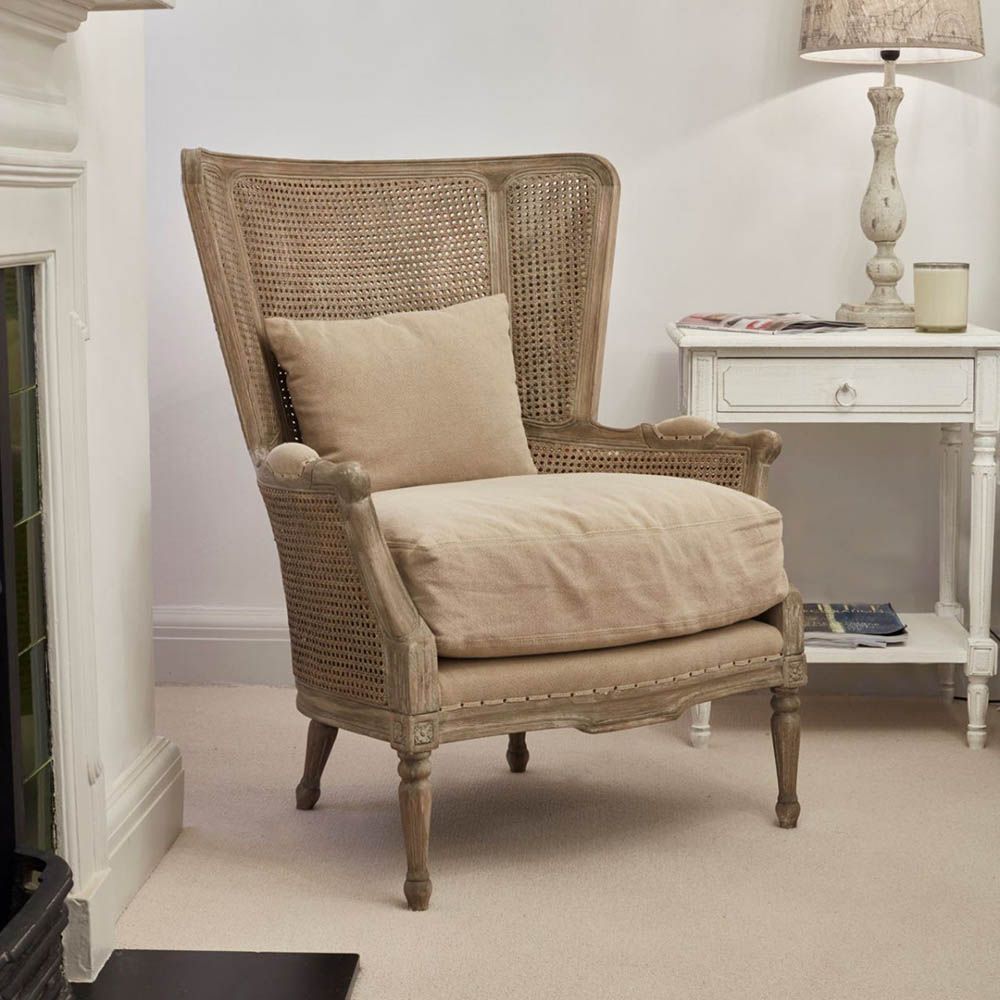 Elegant rattan armchair with linen seat cushion and scatter cushion