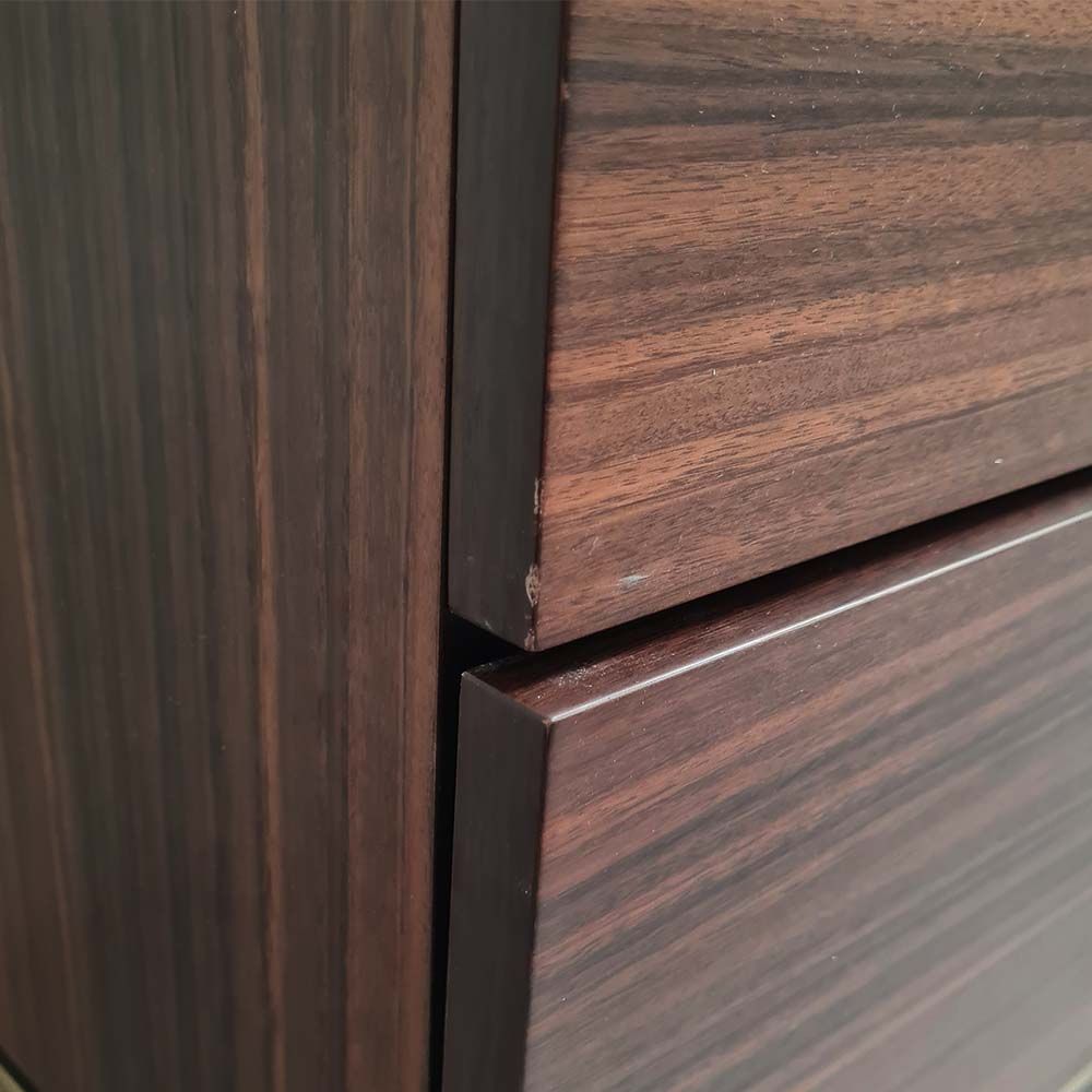 Light brown bedside table with two drawers and brass details