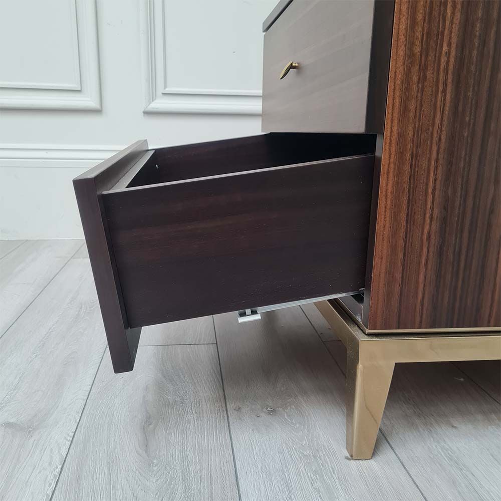 Light brown bedside table with two drawers and brass details