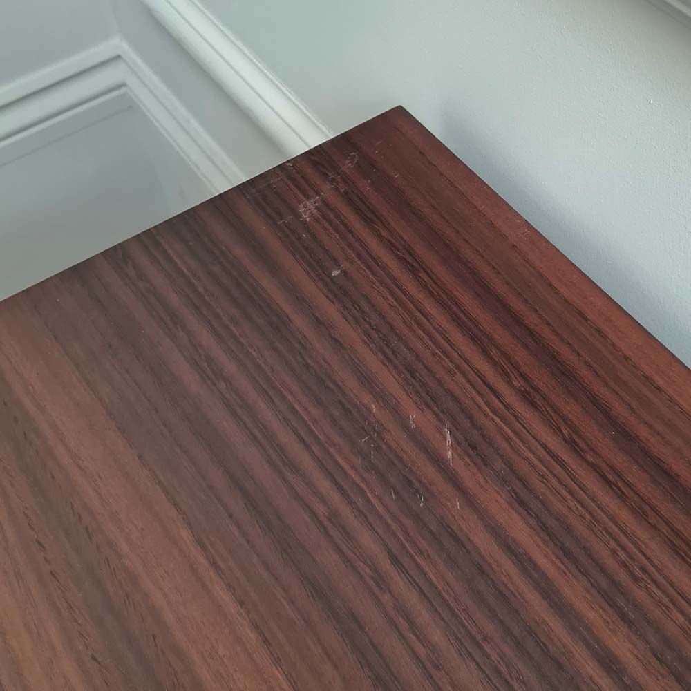 Light brown bedside table with two drawers and brass details
