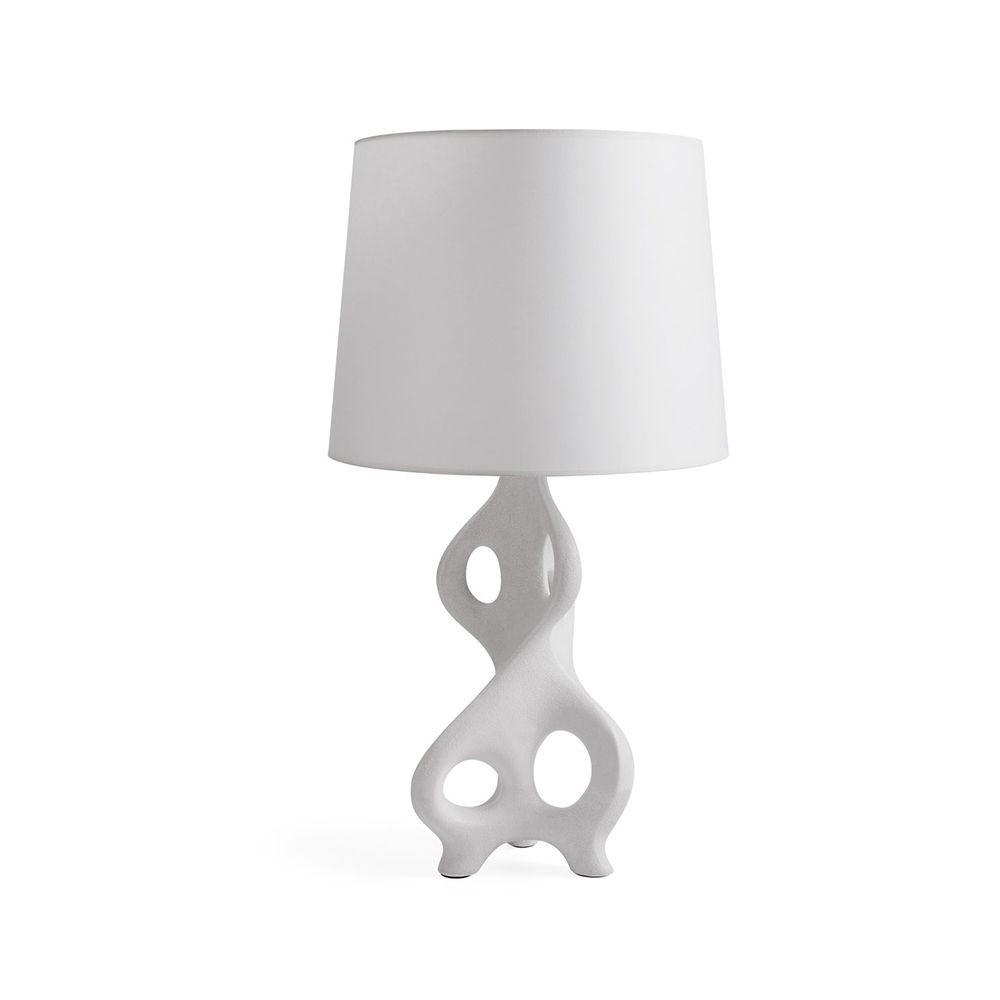 A table lamp by Jonathan Adler crafted from porcelain and finished with a volcanic lava glaze and paper shade