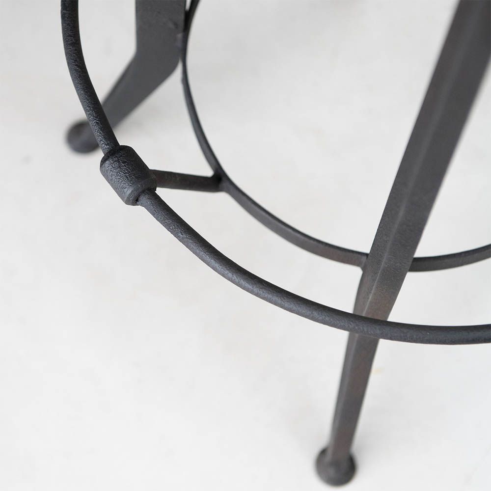 Industrial style bar stool with wooden backrest and seat and dark metal frame