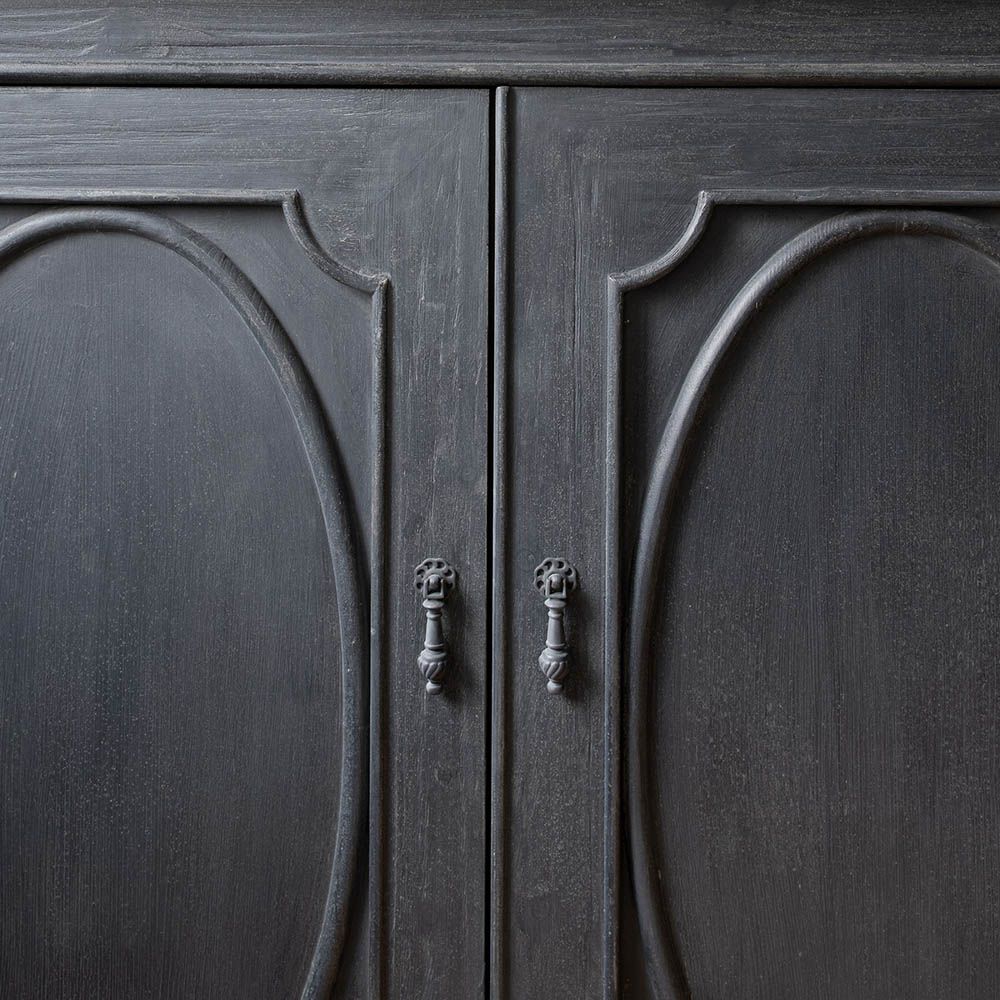 Bold black cabinet with statement panelling on the doors