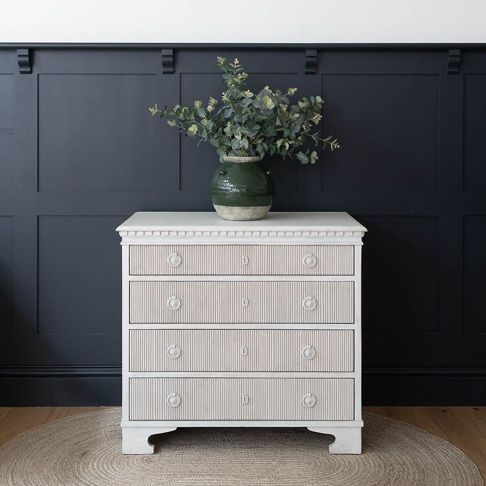 Quaint chest of drawers with ribbed texture on front