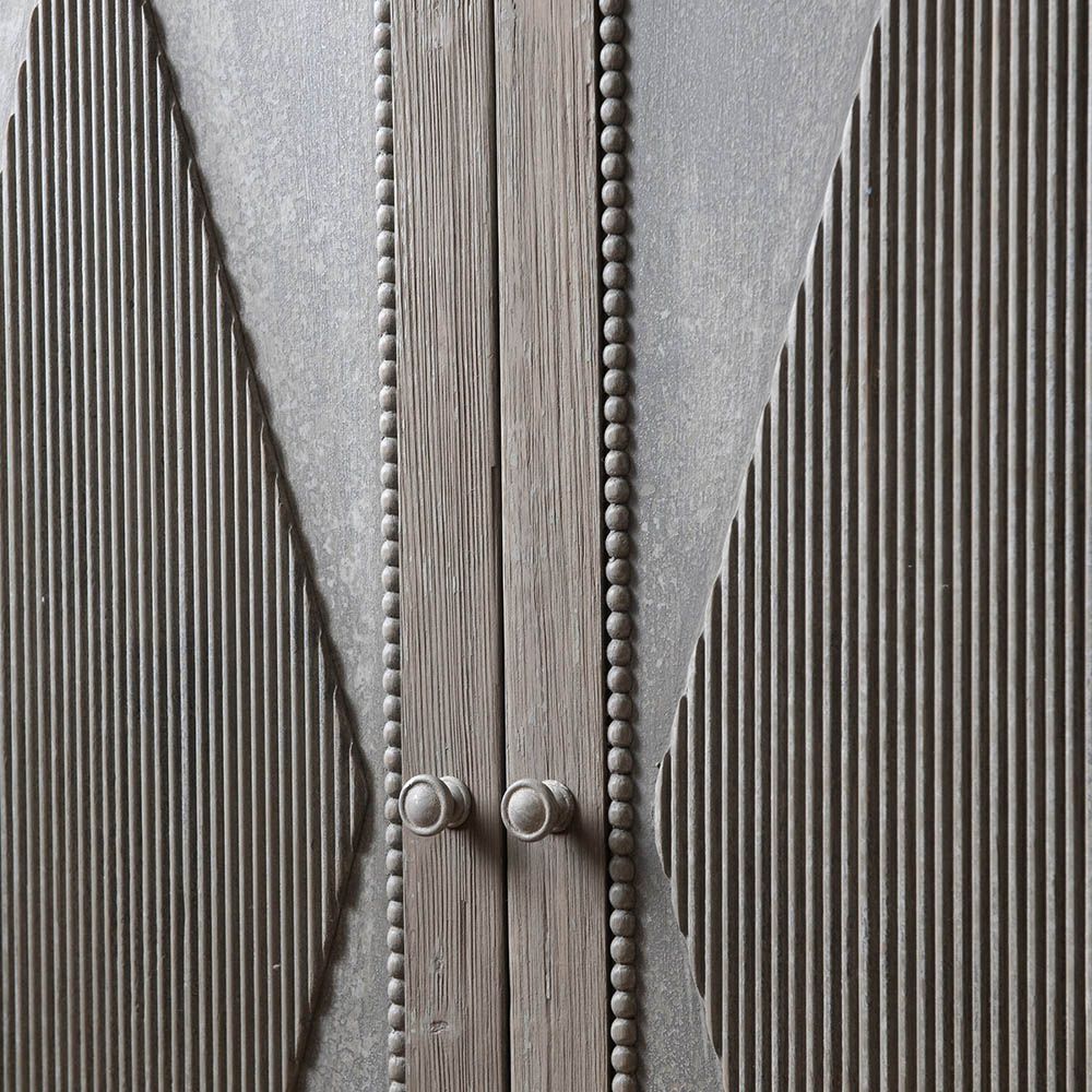 Rustic tall cabinet with ribbed diamond pattern on the doors