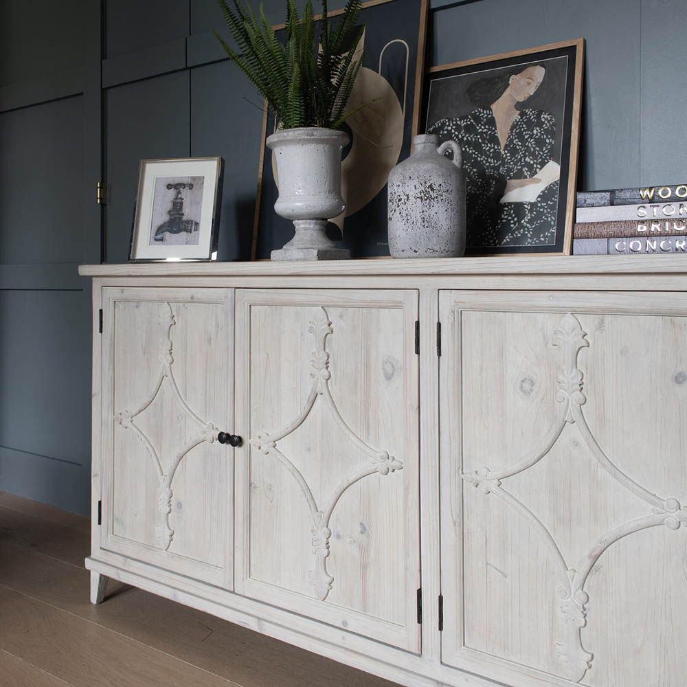 Washed wood sideboard with an elegant pattern on the doors