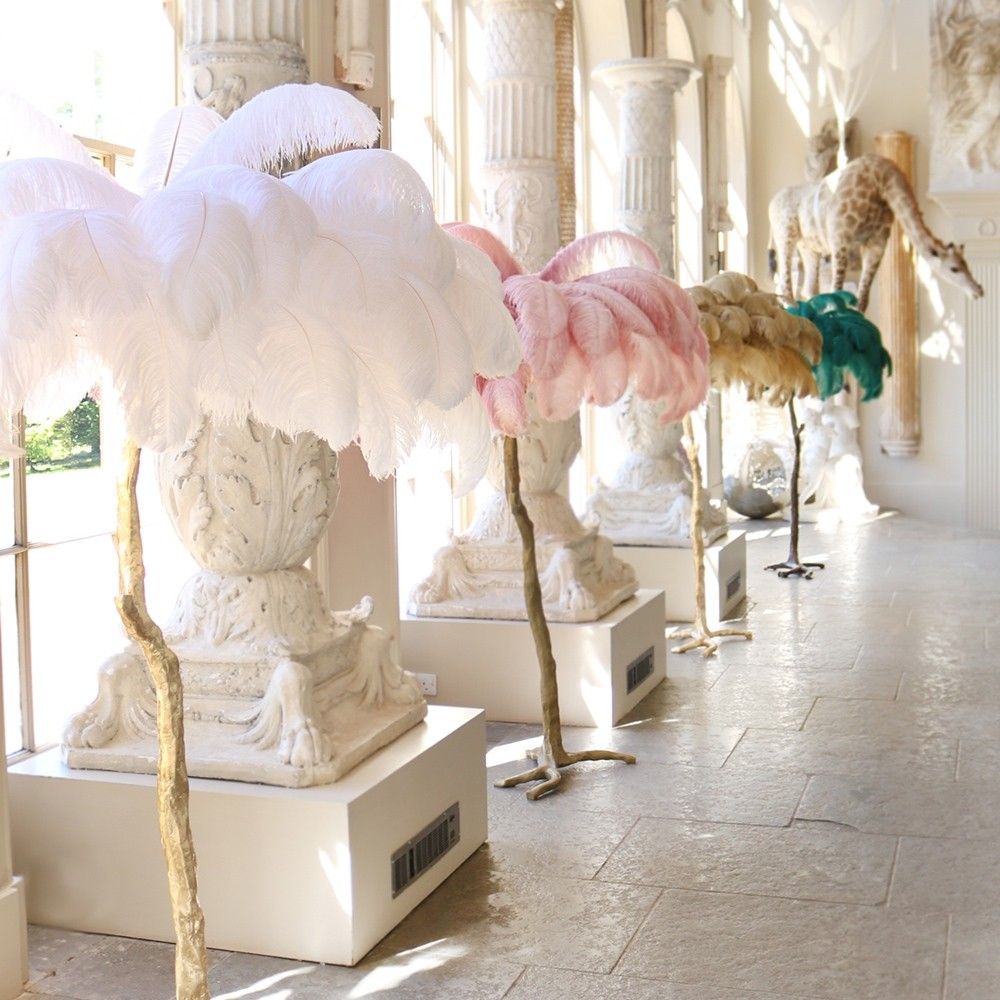 Modern ostrich feather floor lamp with a gold base