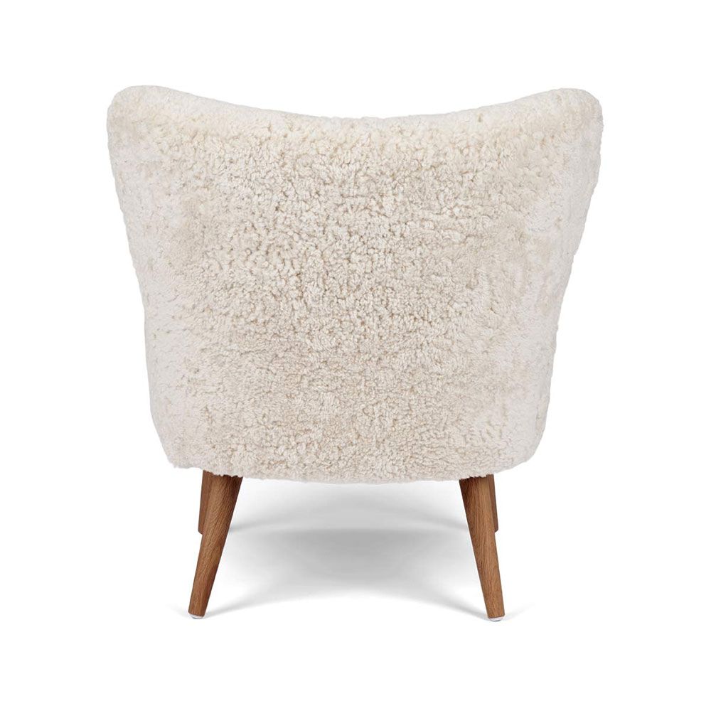 Gorgeously soft sheepskin chair with elegantly tapered walnut wood legs 