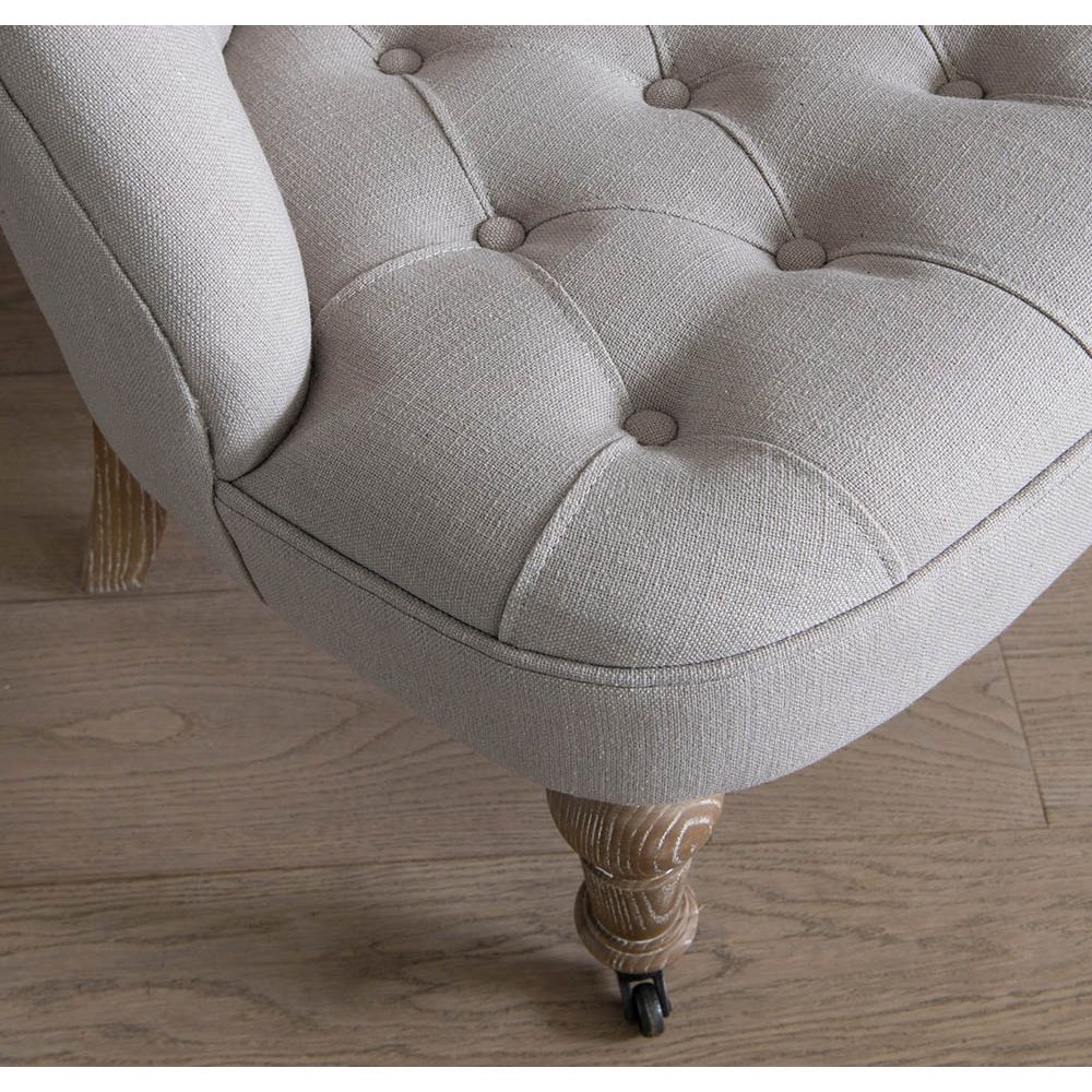 A sophisticated chair with a luxury linen upholstery and deep buttoned design 