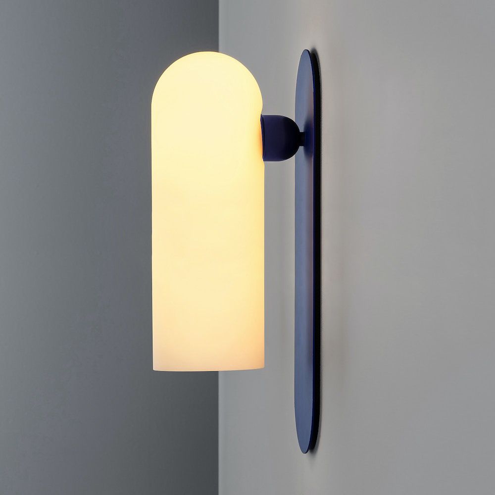 A luxury, large wall light by Schwung with a Santorini Blue finish and glass opal shade