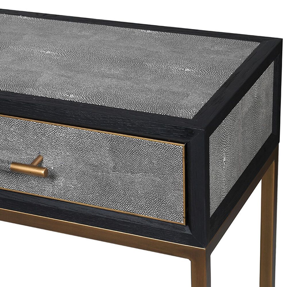 grey shagreen console table with black outlining and brass legs and details 