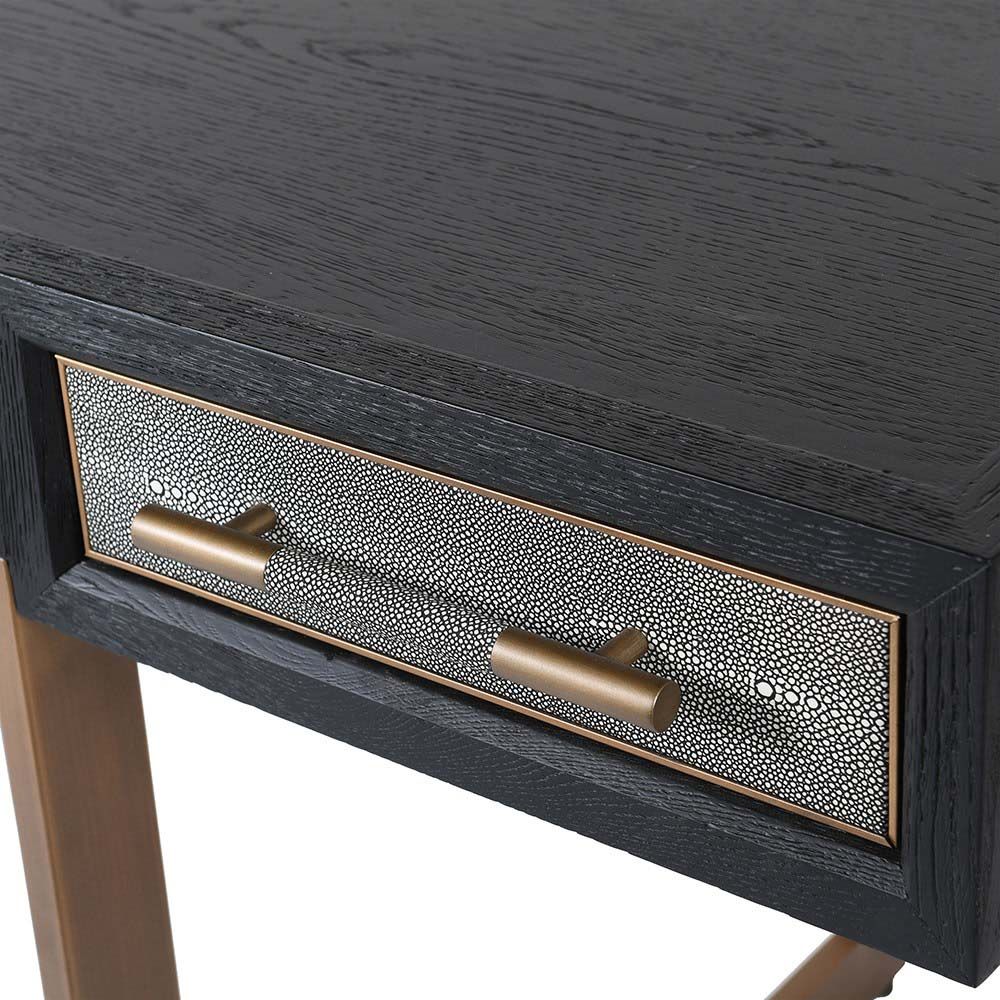 A lavish desk with three spacious drawers, shagreen details and brass hardware
