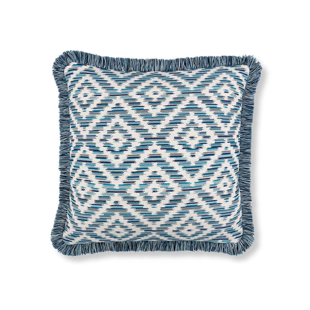 A chevron patterned outdoor cushion with a matching fringe 