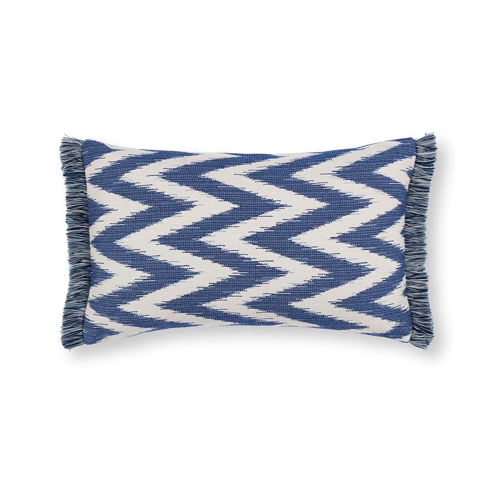 A gorgeous rectangular cushion with a blue and cream zig zag pattern, adorned with a fringe.