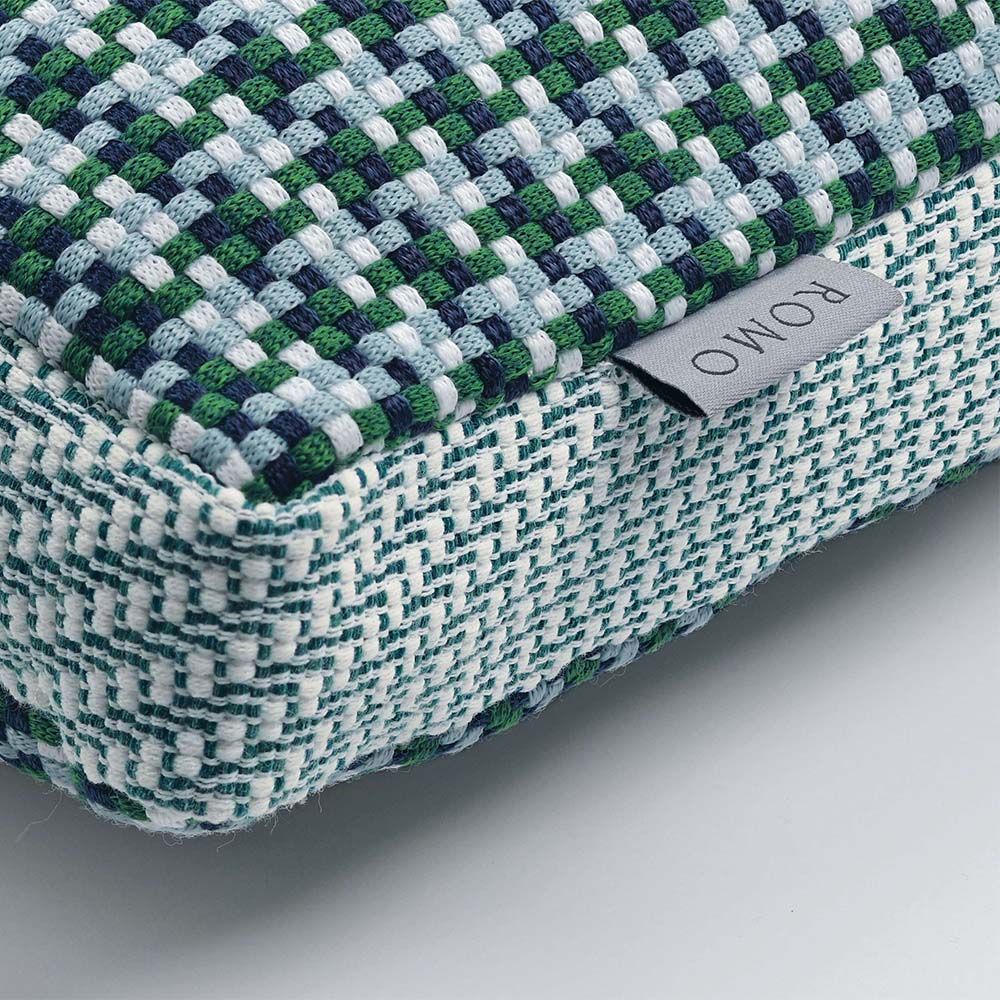 A teal houndstooth inspired outdoor cushion