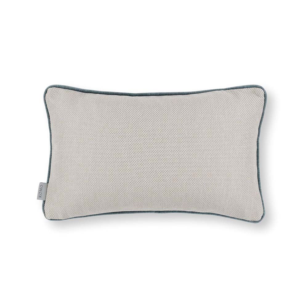 A velvet outdoor cushion with various blue vertical stripes and dark blue piping.