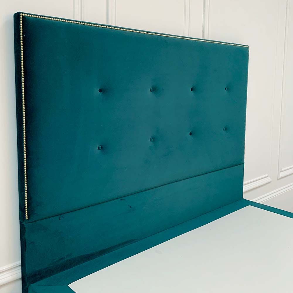 A glamorous gold square studded bed with buttoning detailing and luxury velvet upholstery 