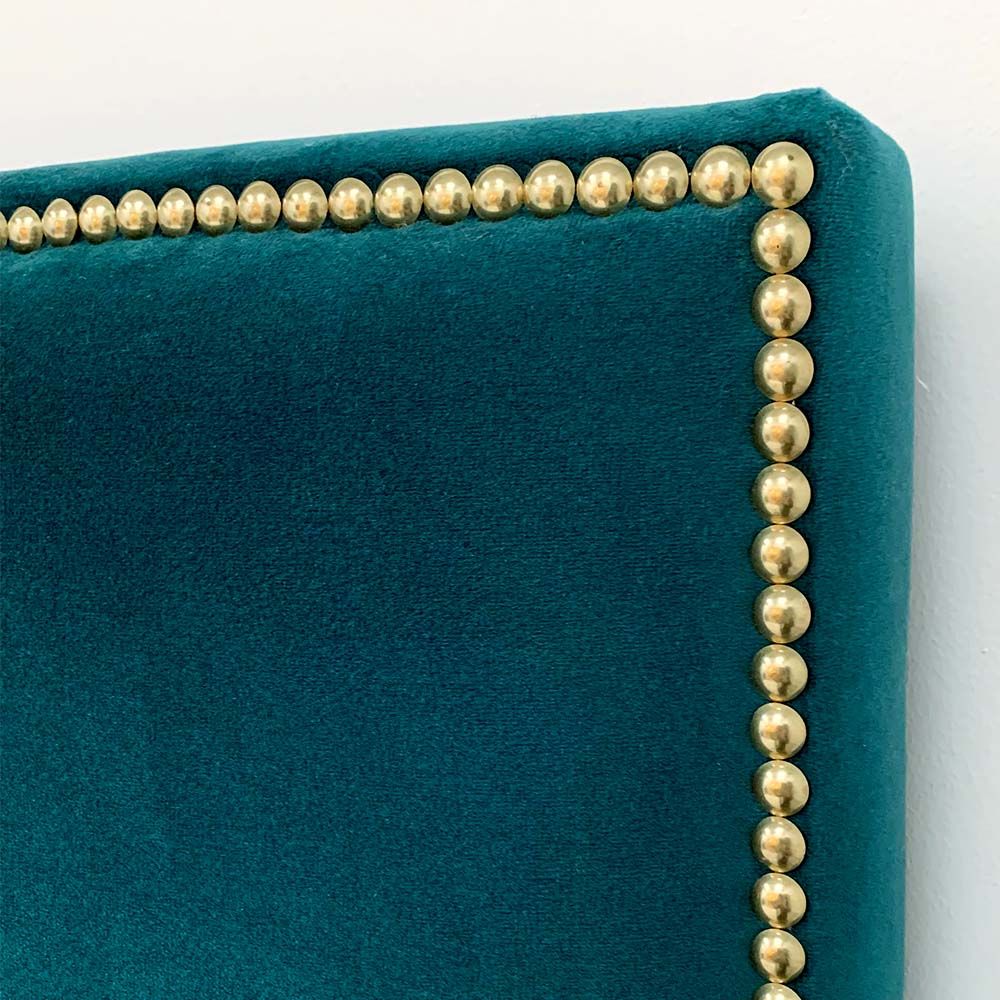 A glamorous gold square studded bed with buttoning detailing and luxury velvet upholstery 
