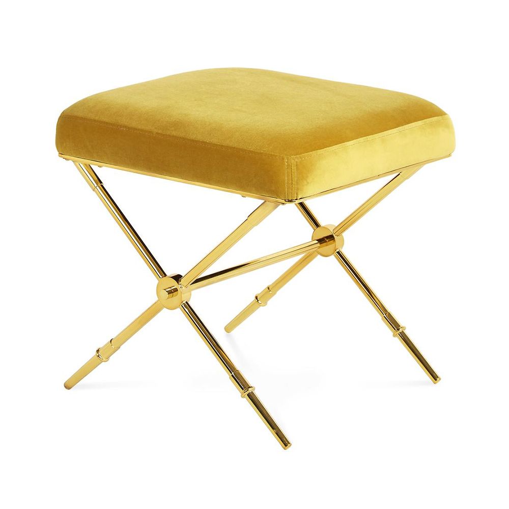 A luxurious stool with golden velvet and a brass base