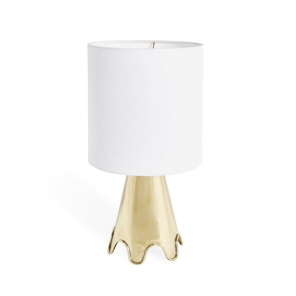 A luxurious, solid polished brass table lamp with a rippled base and a white shade