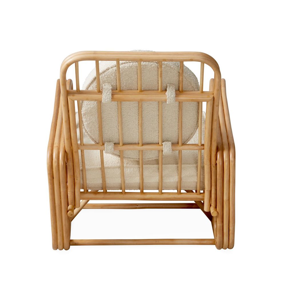 A luxurious rattan and boucle lounge chair by Jonathan Adler