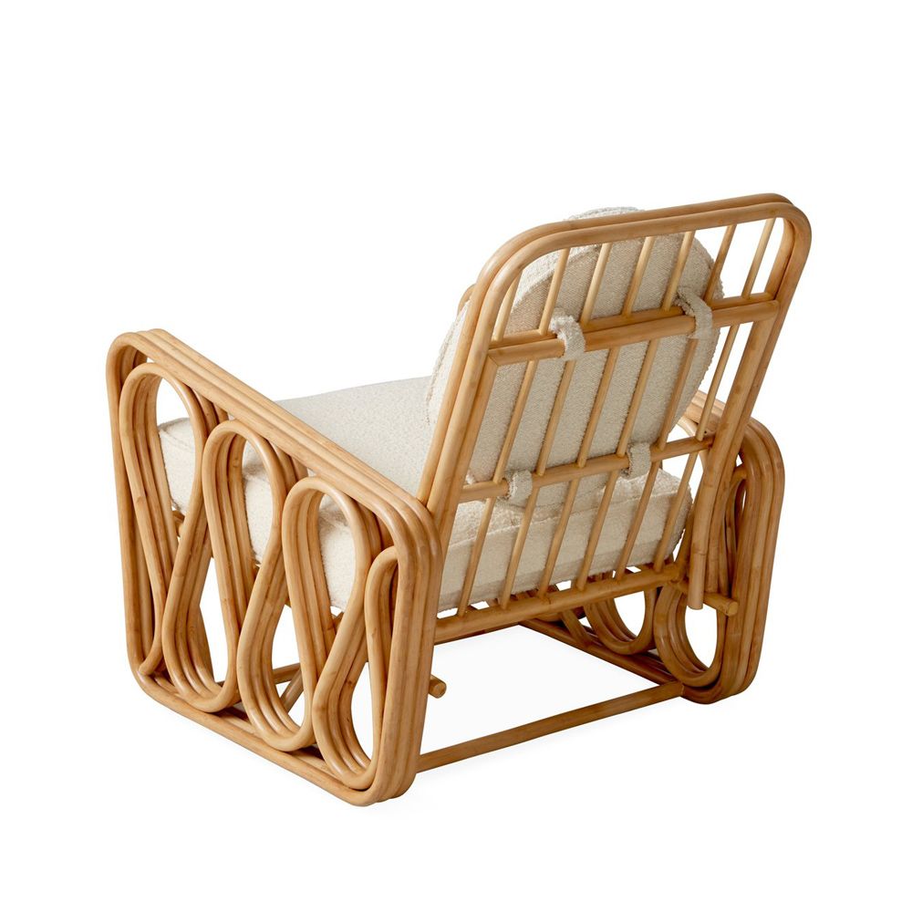 A luxurious rattan and boucle lounge chair by Jonathan Adler