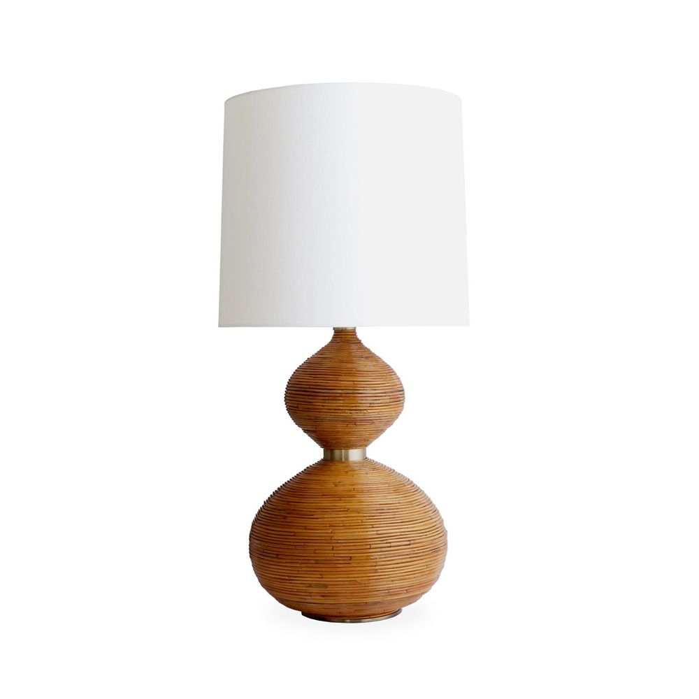 A luxurious honey-toned rattan table lamp with a white lampshade