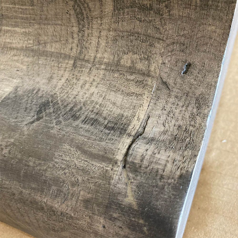 Crack on natural wood of the table leg