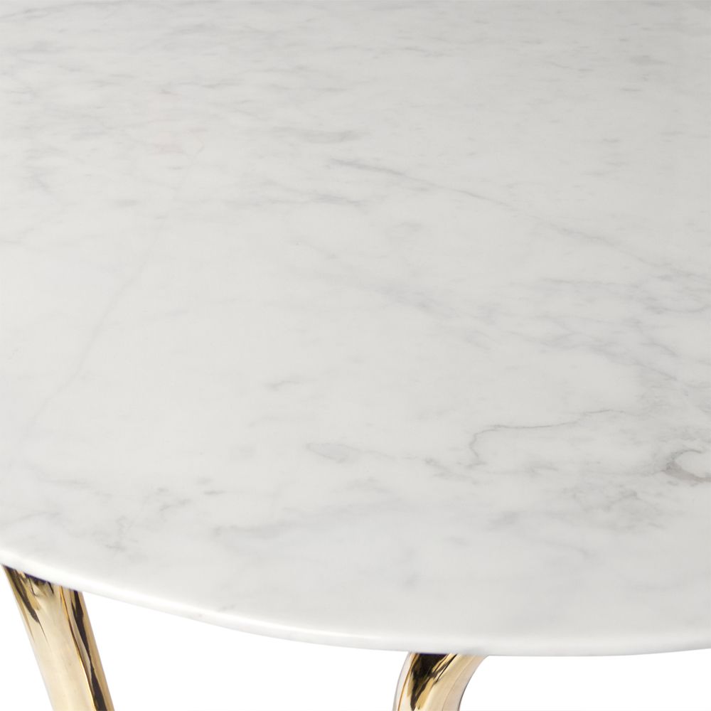 contemporary marble table with a single sinuous brass tube base 