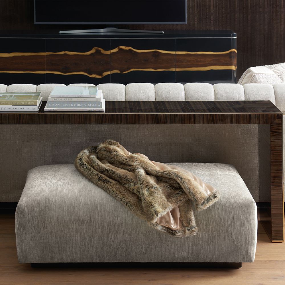 A luxury console table by Caracole with a glamorous gold border
