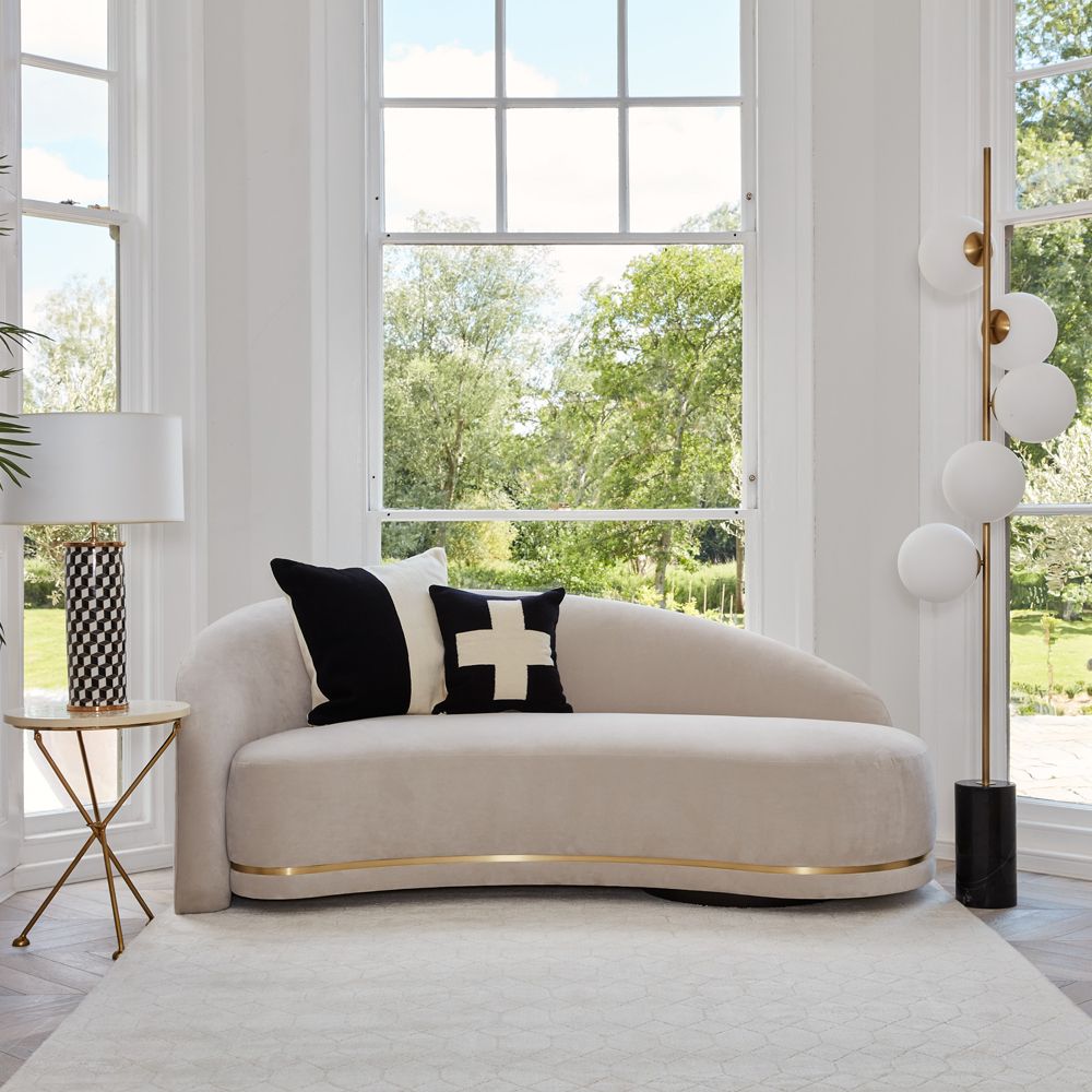 A luxurious Art Deco-inspired sofa with brass-effect detailing. Pictured in COM