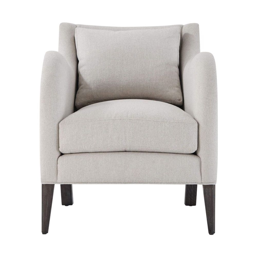 A stylish armchair with a grey upholstery, chic curves and wavy armrests 
