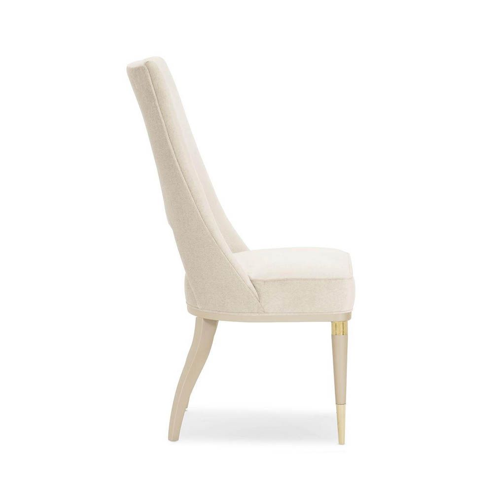 Neutral upholstered dining room chair with peak-through lower back