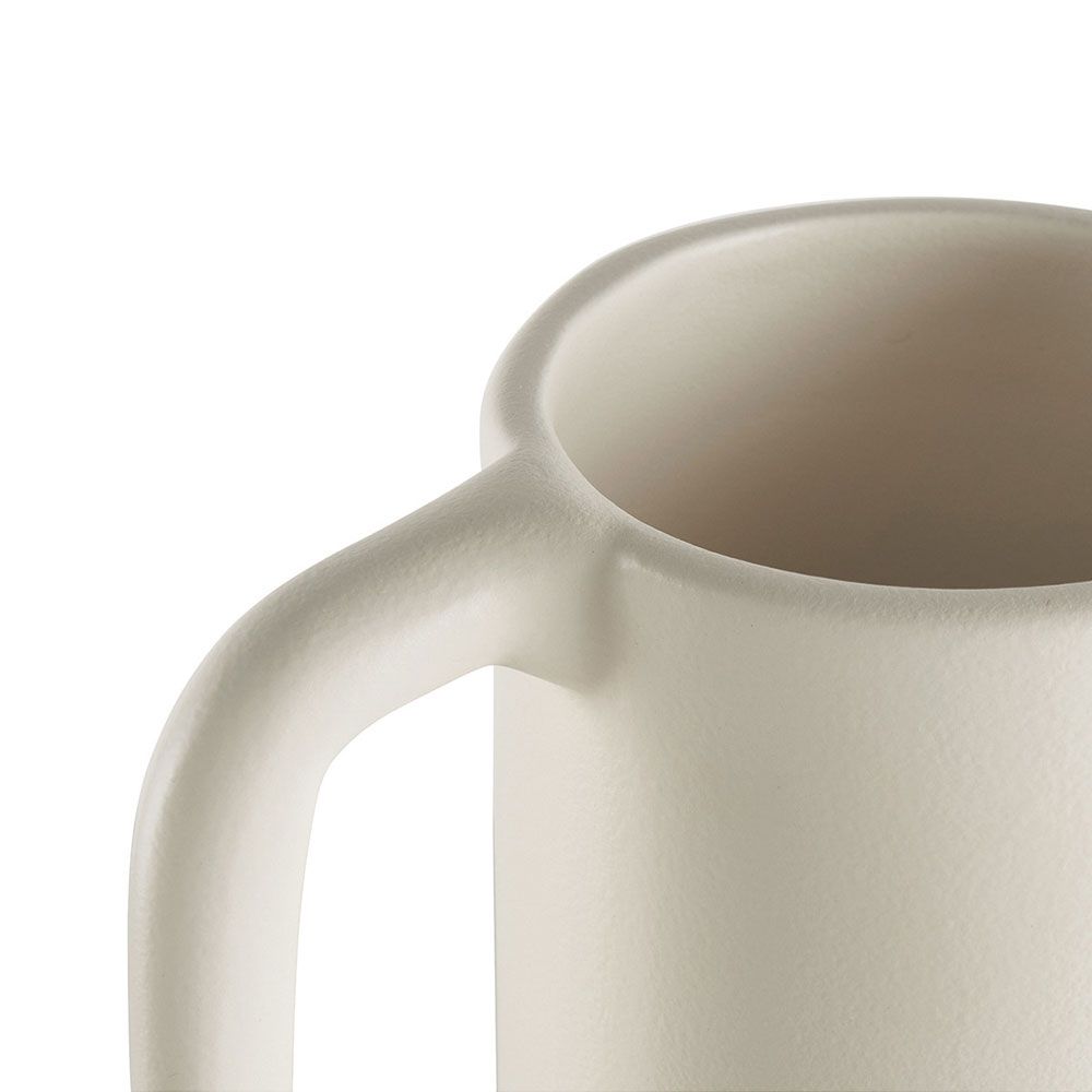Close up of charming handmade vase with long handle and white finish