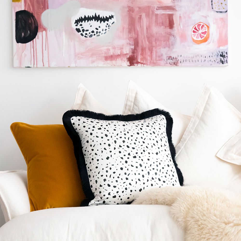 A stylish velvet cushion with a mustard colour and square shape